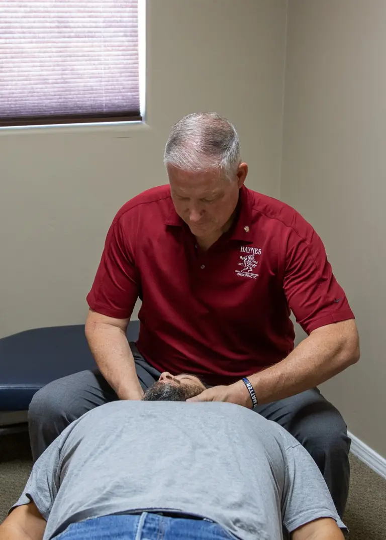 Dr. Haynes adjusting a patient on a treatment table